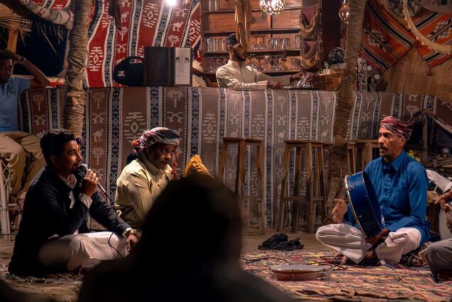 Musicians performing traditional Egyptian music in a cozy tent setting