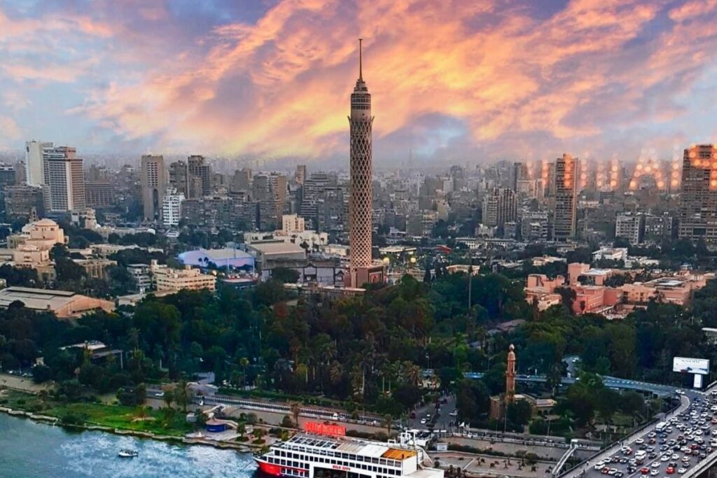 The Cairo Tower standing tall against the backdrop of a vibrant sunset in the bustling city of Cairo