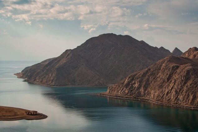 Stunning view of Taba's coastline with crystal-clear waters and mountains in the distance