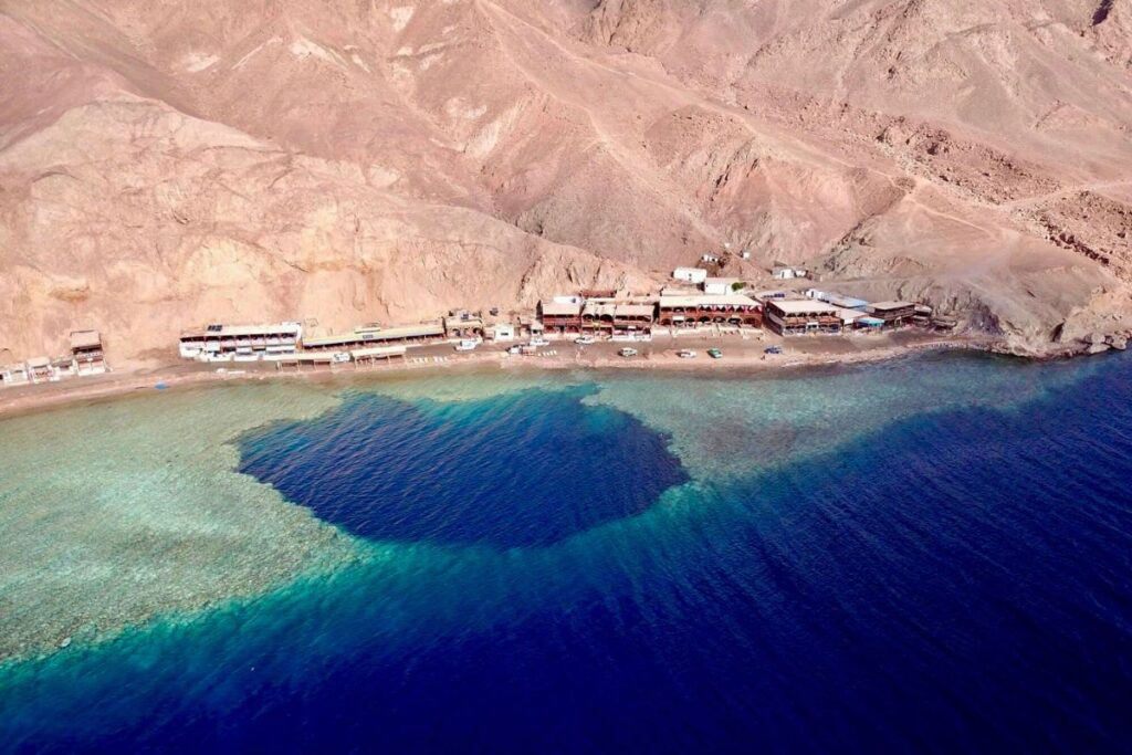 Aerial view of a coastal area with turquoise waters and sandy beach