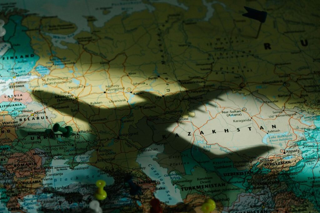 Shadow of an airplane flying over a map of Eastern Europe and Central Asia