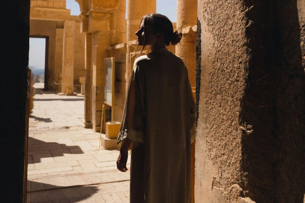 Silhouette of a woman exploring an ancient Egyptian temple