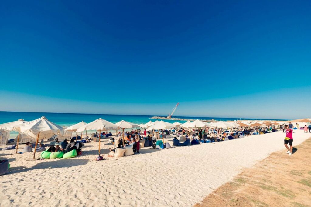 Crowded beach with umbrellas and lounge areas