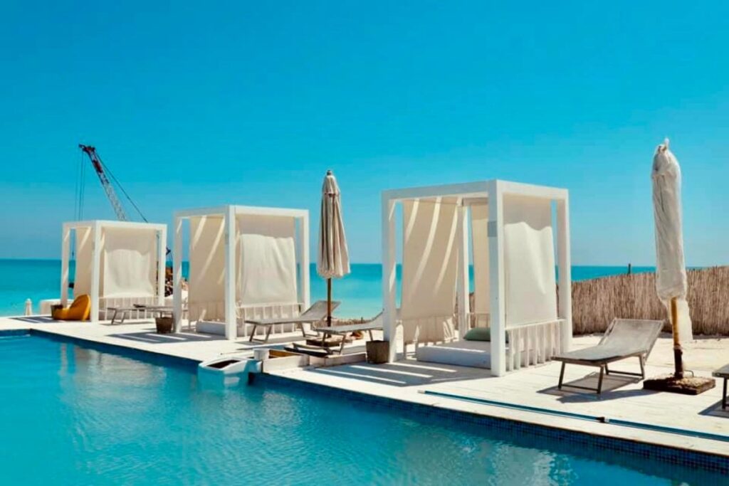 White poolside cabanas overlooking the beach