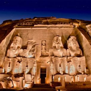 The illuminated statues of Abu Simbel temple at night, showcasing ancient Egyptian architecture